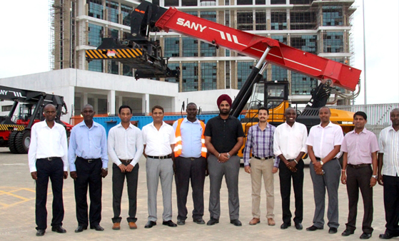 Team members beside cargo handling equipment