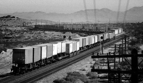 Freight train carrying cargo along a railway line