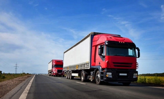 Heavy trucks transporting cargo along a road