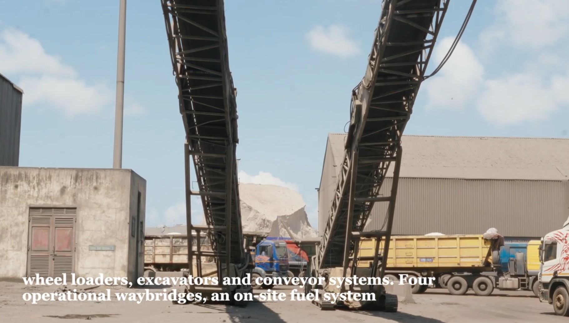 Bulk cargo trucks and conveyor equipment at the depot