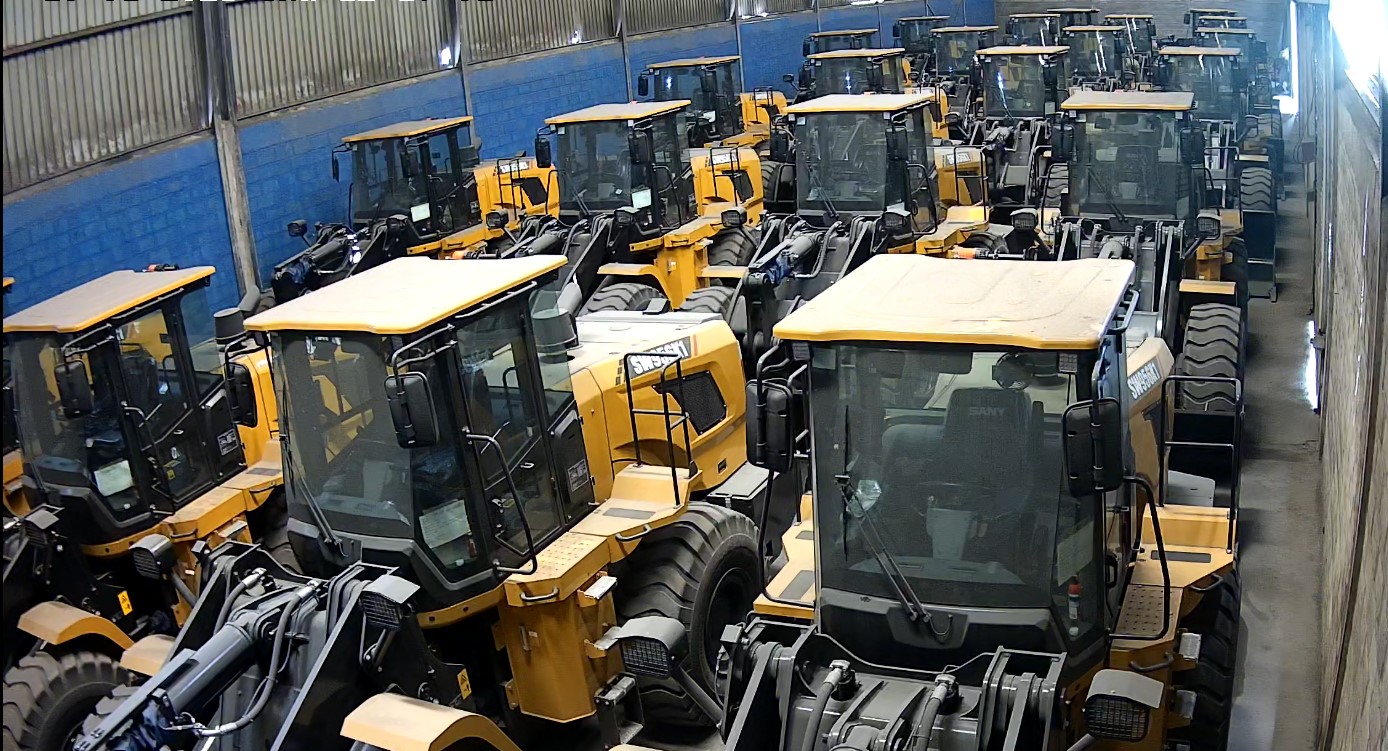 Wheel loaders stored inside a covered equipment warehouse